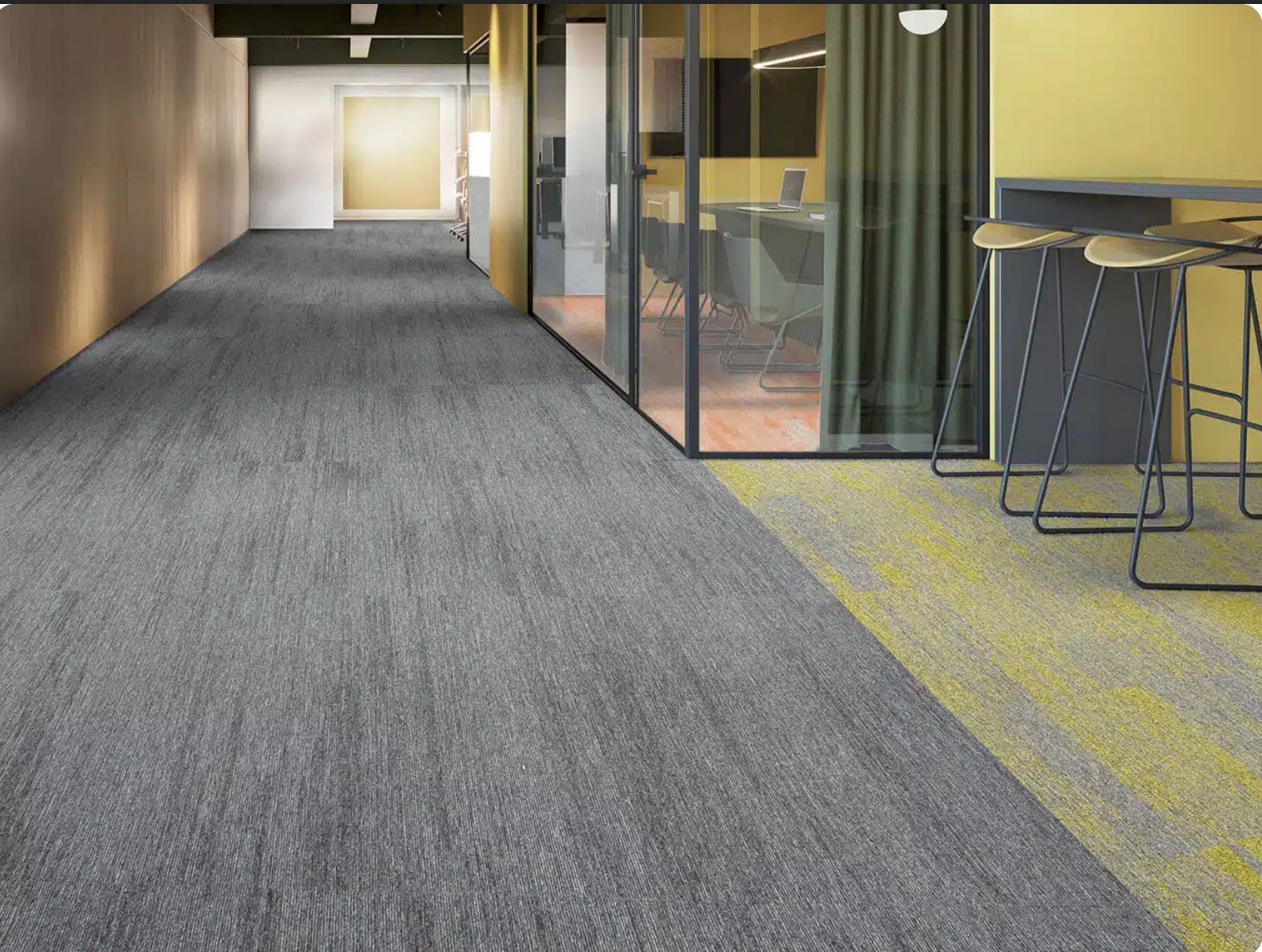 Grey and green office carpet tiles installed in a Dubai workplace corridor